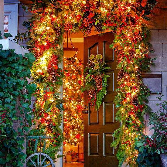 Christmas front door decoration garlands of lights and greenery