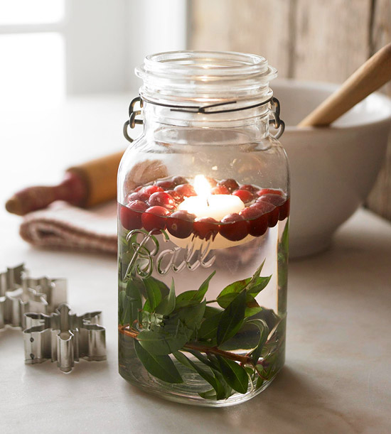 Glass jar filled with berries and candle