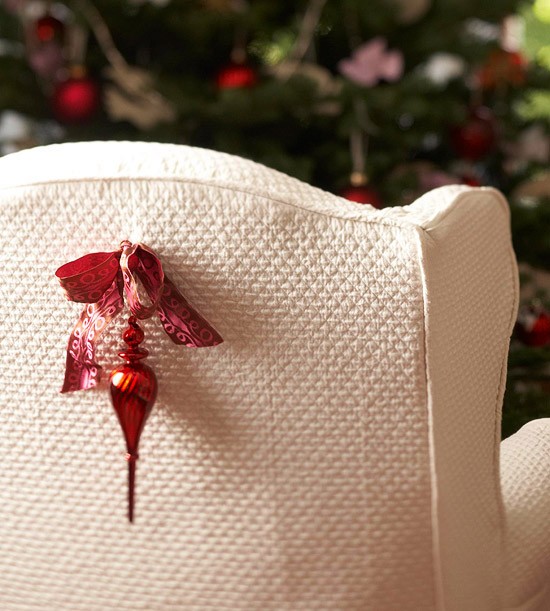 Red christmas accent on a white armchair