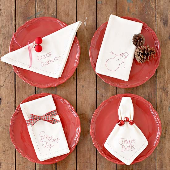 embroidered christmas napkins ribbons and pinecones