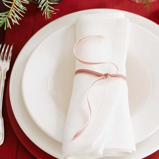tiny elegant christmas ribbon on white cloth napkin