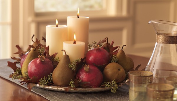 elegant centerpiece candles pears pomegranates
