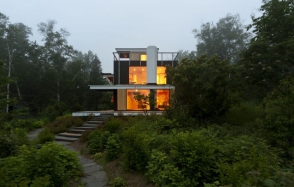 Minimalist house in forest garage solar panels energy concept