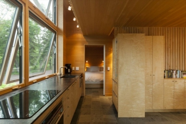 contemporary cliff house in forest triple glazed wall paneling warm interior design