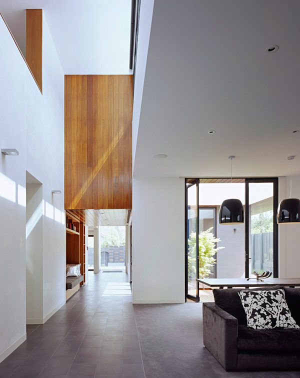 Caulfield House by Bower Architecture low ceiling entry opens to double height gallery
