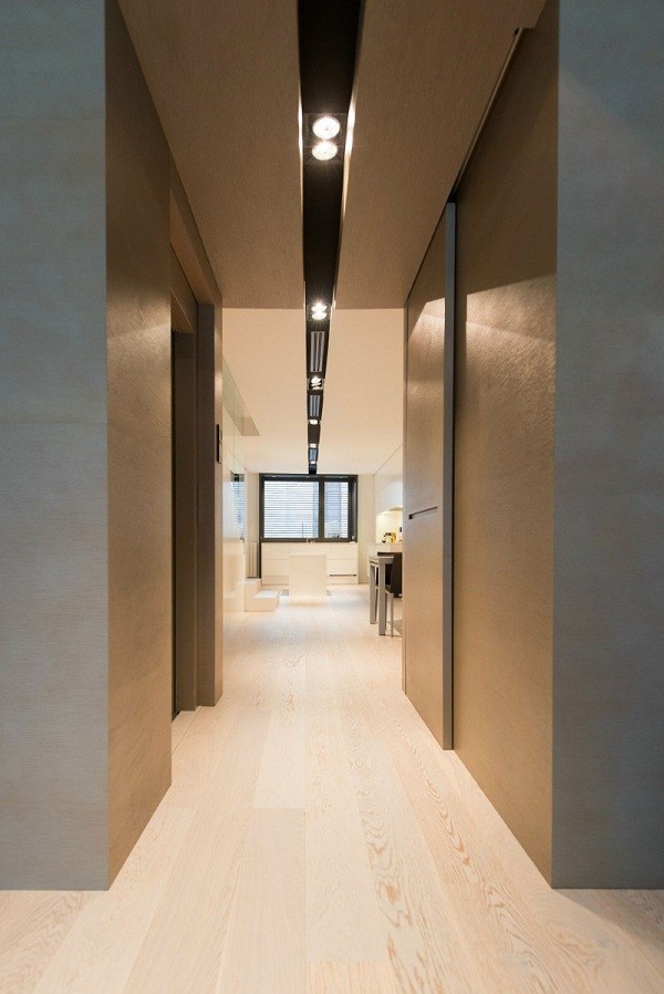 Long corridor grey walls recessed lighting