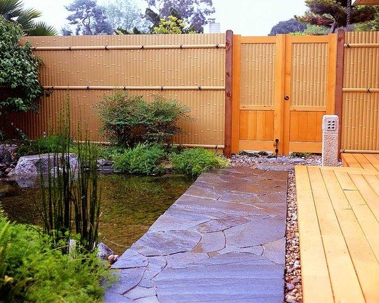 Solid high privacy bamboo garden fence pond stone path