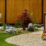 bamboo-garden-fence-Japanese-style-landscape-plants-lawn-pebble-path-high-vertical-fence