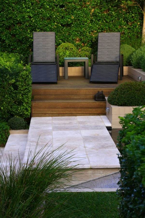 creative landscape design wooden deck patio furniture rattan chairs hedge plants