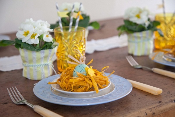 festive table decoration for easter blue dishes yellow glasses