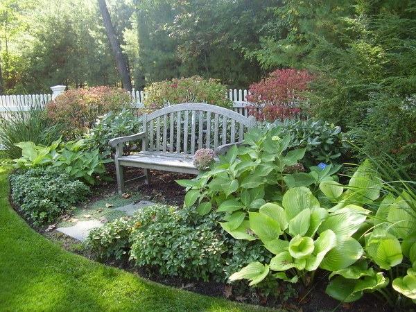 garden design ideas wooden bench high perennials pavers