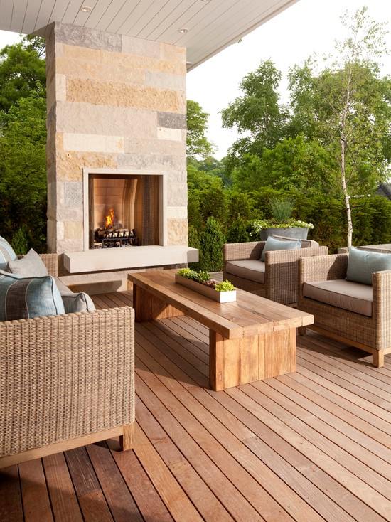 gorgeous wooden deck with fireplace and armchairs