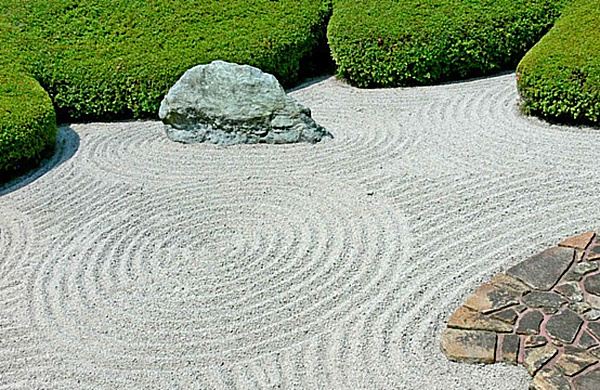 zen rock garden raked pebbles decorative rocks green border