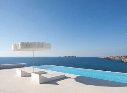 Glass-railing-infinity-pool-ocean-view-recliner-white-terrace