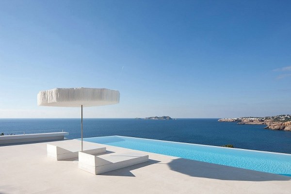 Glass railing infinity pool ocean view recliner white terrace