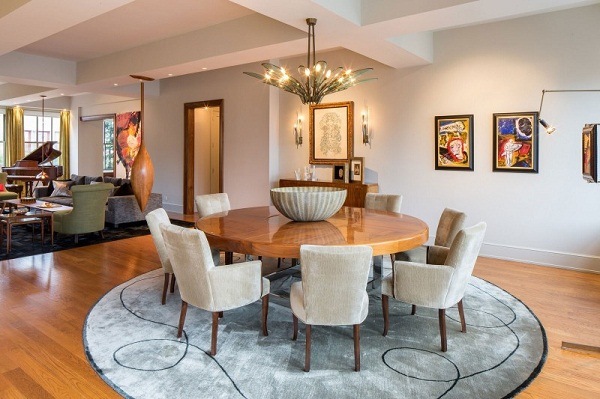 round wooden dining table carpet apartment in NYC