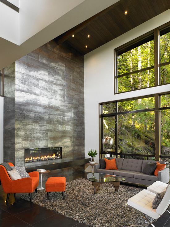 Stone wall fireplace shaggy carpet gray orange armchair
