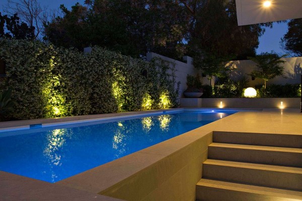 contemporary house exterior landscape ideas outdoor swimming pool backyard lighting Branksome