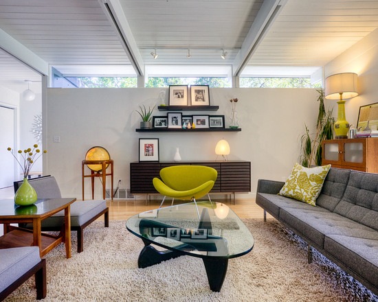 green armchair glass coffee table gray sofa design wall shelf shaggy carpet