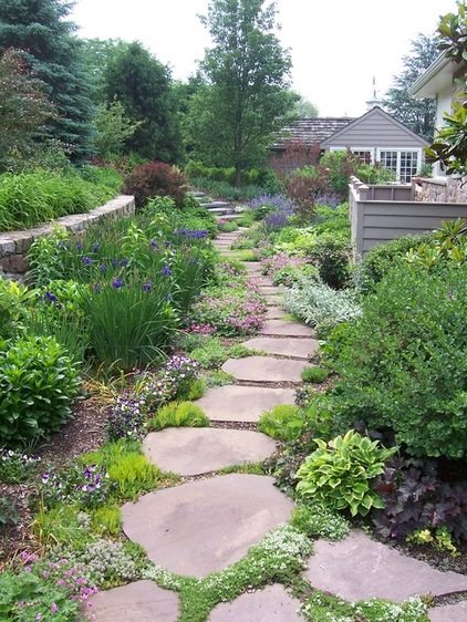 landscape design stone path garden retaining wall leads to side yard patio