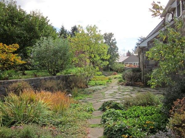 picturesque garden design stone foothpath along reataining wall