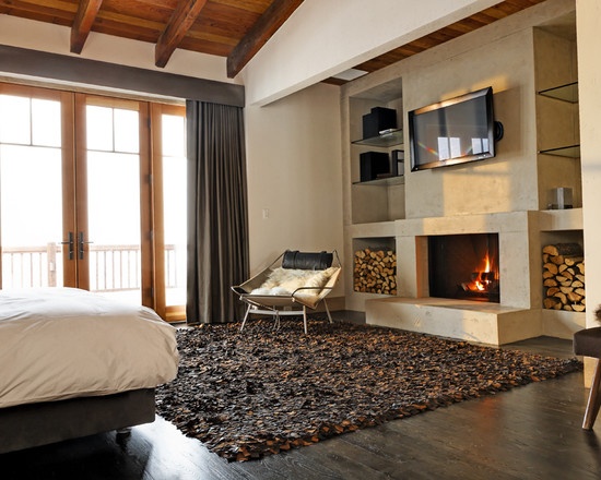 rustic interior fireplace wooden beams ceiling shaggy carpet brown color