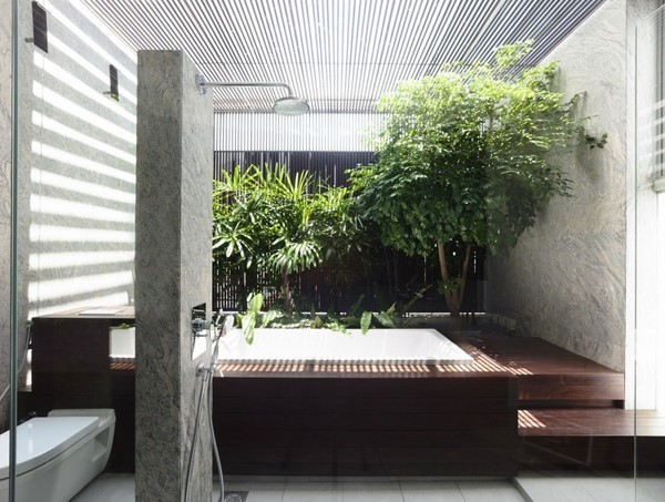 wellness bathroom stone wall tub plants glass ceiling 
