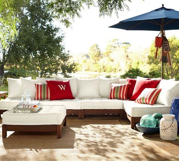 wooden-outdoor-furniture-low-sectional-sofa-blue-umbrella-colorful-accent-cushions