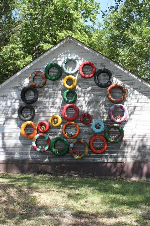Garden Ideas with old car tire peace sign wall