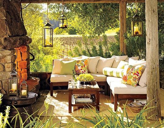 Garden design ideas fireplace lantern candles pillows