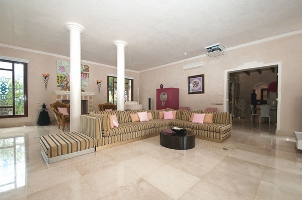 Ibiza villa living room pillars fireplace big corner sofa
