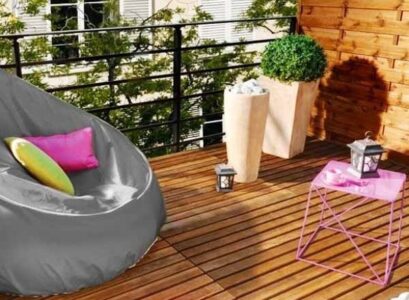 Small-balcony-design-ideas-large-armchair-modern-planters-small-coffee-table