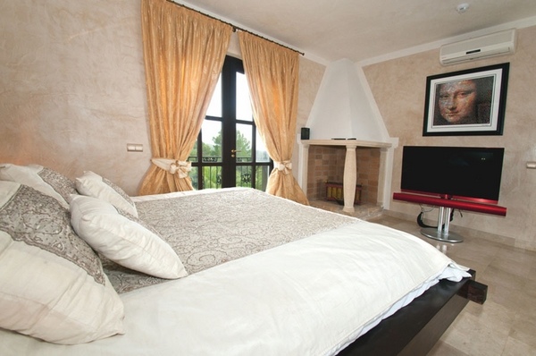 luxury Ibiza villa interior design large bedroom fireplace