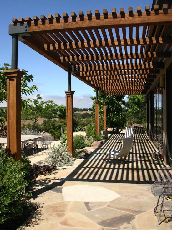 contemporary house exterior wooden pergola stone flooring