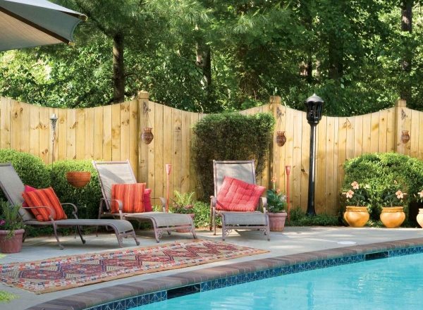 Garden with pool loungers wooden privacy protection fence