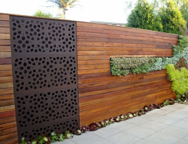 Metal gates wooden privacy fence decorative stones