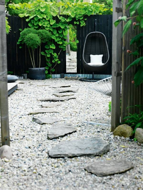 Wooden garden fence hanging chair stone path 