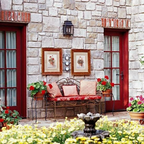 Wrought iron bench stone wall house facade