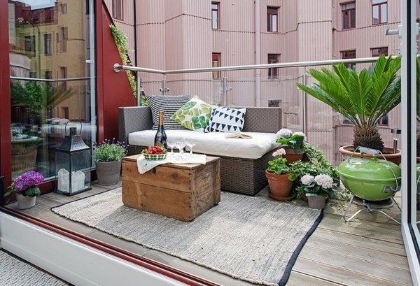 balcony-glass-railing-old-wooden-chest-coffee table-rattan-sofa