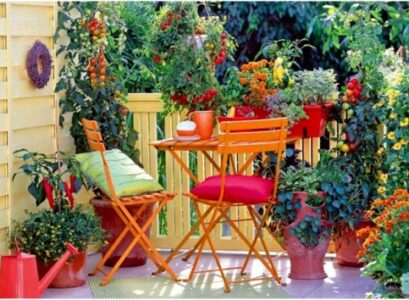 colorful-flower-pots-balcony-privacy-protection-folding-chairs-wooden-table