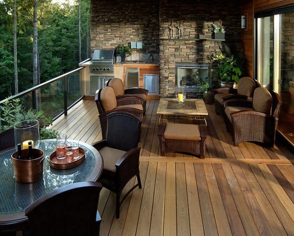 covered terrace outside kitchen glass railing and natural stone wall