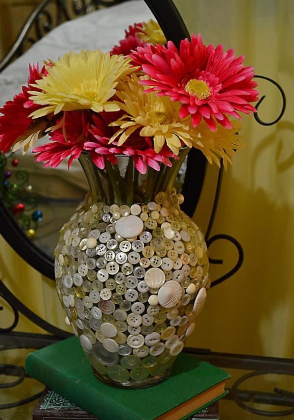glass vase decorated with buttons