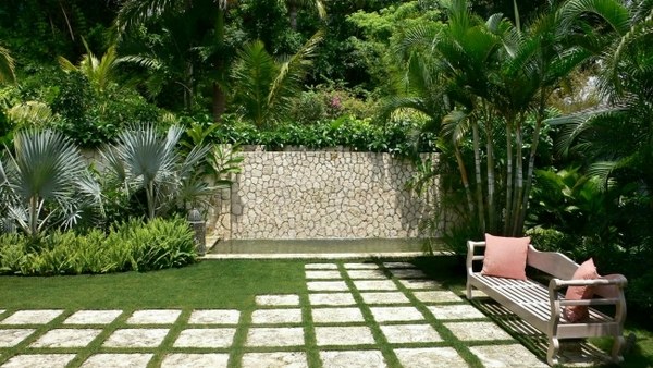 landscaping ideas bench palm trees stone wall