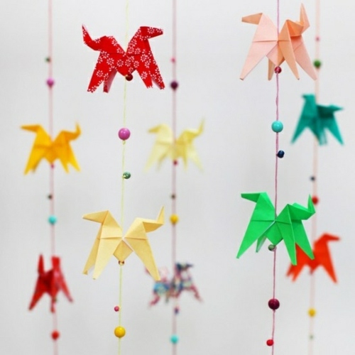 Origami folding- flowers, stars and animals as nursery room decoration