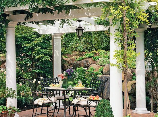 privacy-protection-in-the-garden-hedge-white-pergola-wrought-iron-furniture