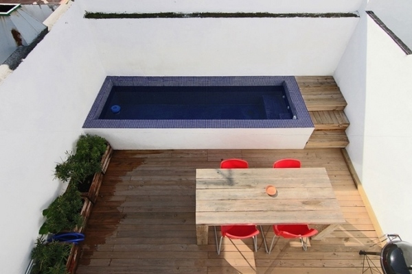small roof balcony high wall pool wooden floor dining table