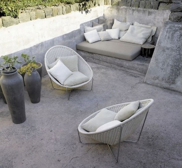 small terrace concrete flooring pillow armchair clay pots
