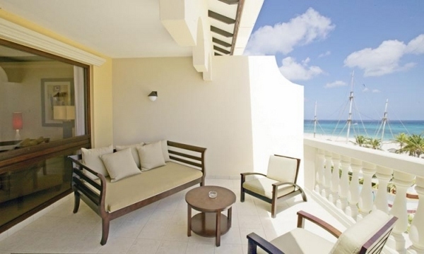 sunny balcony white wood furniture beach view