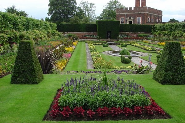 Spectacular English garden symmetric flower beds shrubs trees