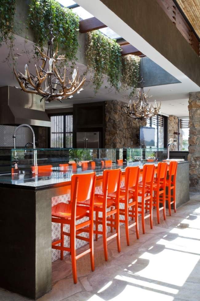 eclectic kitchen orange barstools chandelier